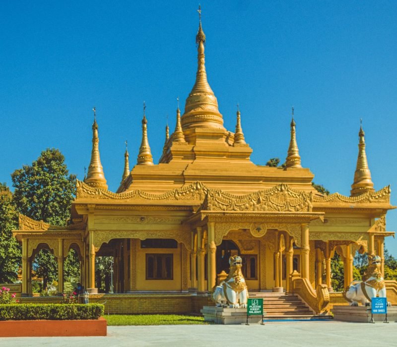 a large yellow building with many spires on top of it