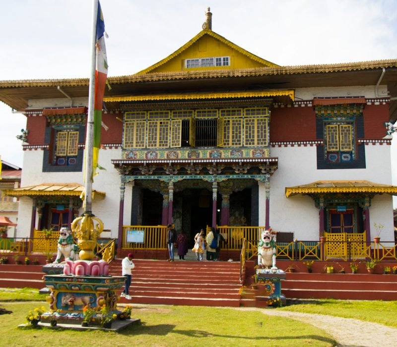 A large building with many flags flying in front of it